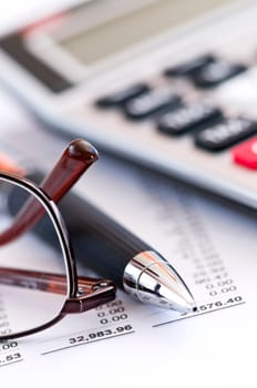 Tax calculator pen and glasses