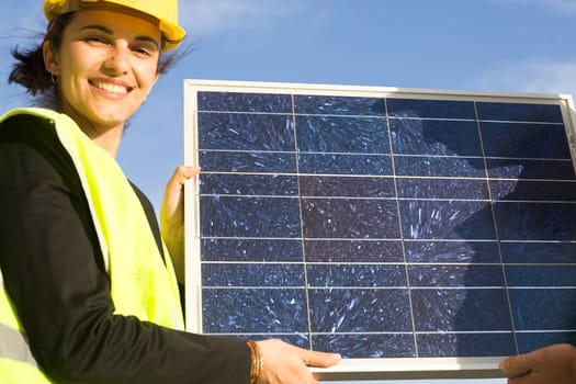Woman holding a solar panel