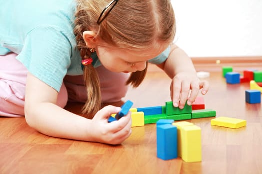 Adorable girl playing with blocks