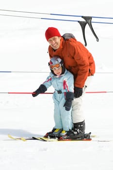 Father with daughter skiing together