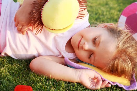 Happy girl relaxing on a grass