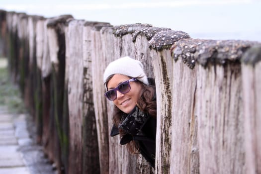 young woman looking out from between stages