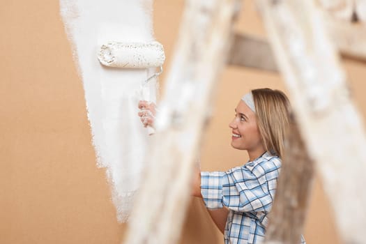 Home improvement Young woman with paint roller