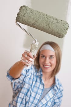 Home improvement Young woman with paint roller