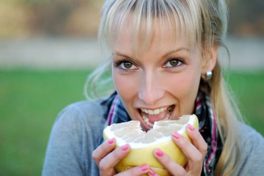 Young woman with pomelo