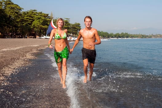 Couple running on the beach