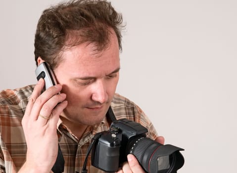 man with camera and phone