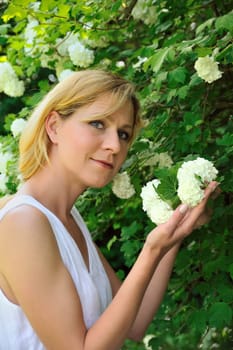 Young woman gardening - taking care of snowball