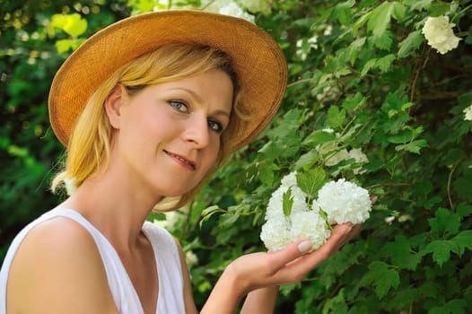 Young woman gardening - taking care of snowball