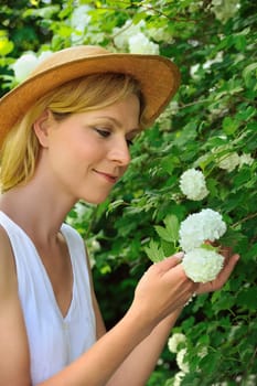 Young woman gardening - taking care of snowball
