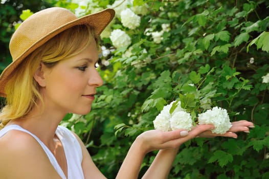 Young woman gardening - taking care of snowball