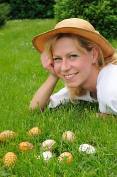 Young woman and easter eggs on grass - Easter time