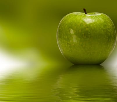Green apple reflected in to the water