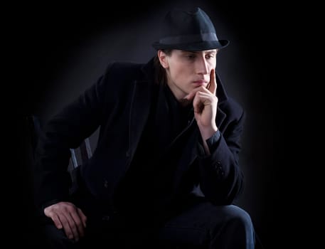 Man in black cloth think with serious look