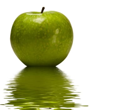 Green apple reflected in to the water