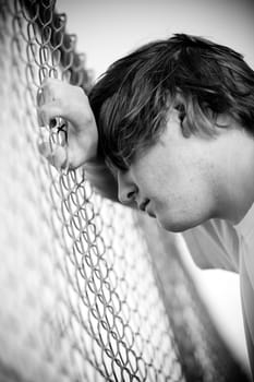 Teen against fence