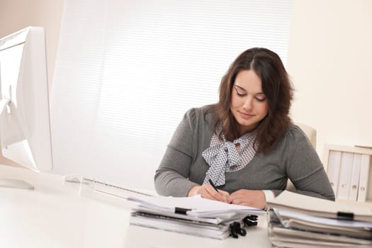Young businesswoman working at office