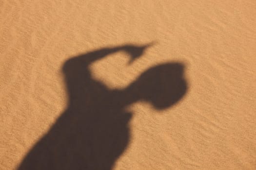 shadow of boy in sand