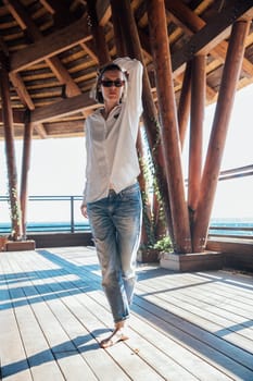 woman stands on a wooden floor in an open room