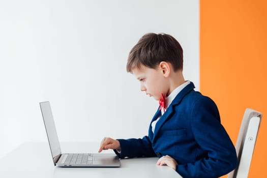 education IT knowledge child sitting at laptop at school