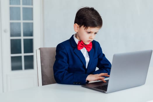 education IT knowledge child sitting at laptop at school