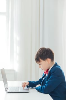 child sits at a laptop at a school education IT knowledge