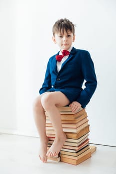 a child sitting on books gets knowledge learning reading science