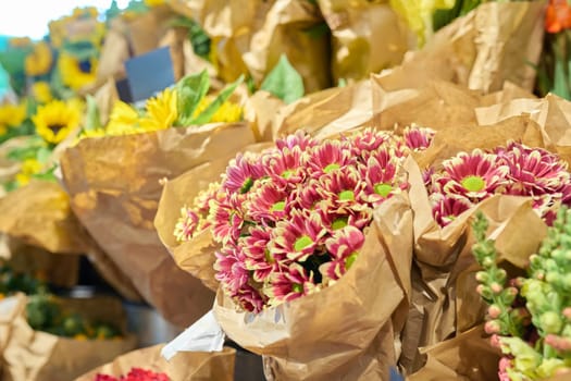 Flower shop, close-up of fresh flowers in buckets, pink chrysanthemums. Floristics, small business, flower decoration of apartments, houses, offices, gifts for holidays, summer autumn season