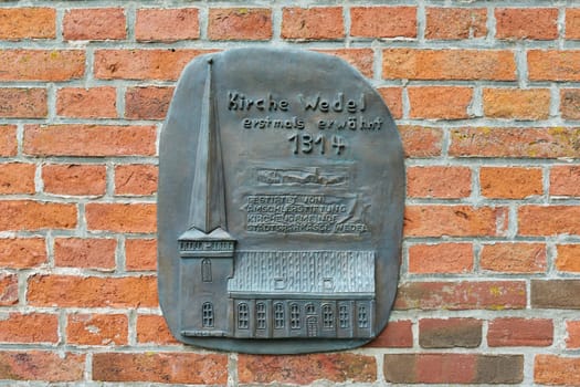 Wedel Germany, 1.08.2023, Memorial plaque with text church first mentioned in 1314 donated by amschlerstiftung parish stadtsparkasse Wedel