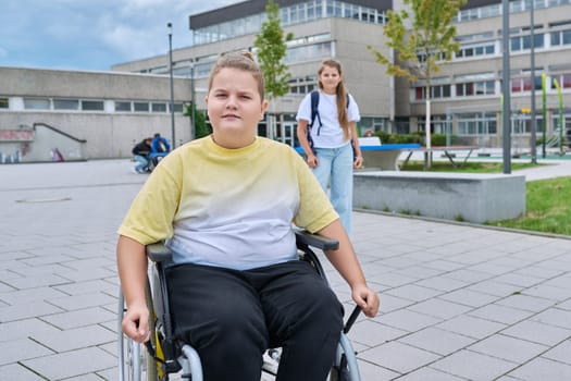 Children go to school, boy 11, 12 years old on a wheelchair close-up. Education, childhood, health, disability, inclusiveness concept