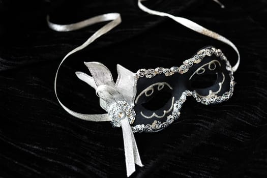 Carnival mask with a beautiful design on a black background. Chic and shine. Holiday and masquerade concept