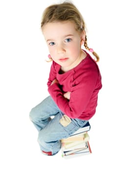 Child on a pile of books