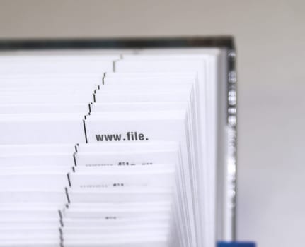 The cutting face of a phone directory with fanned pages.