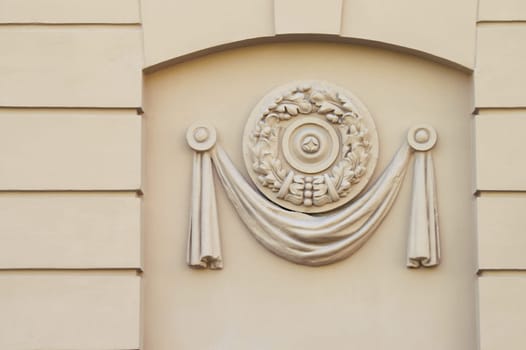 A close-up detail of a building facade decor. A moulded plastic panel. Early sov