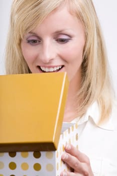 Beautiful woman opening a gift
