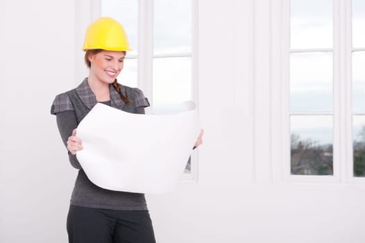 Young female architect with a blueprint