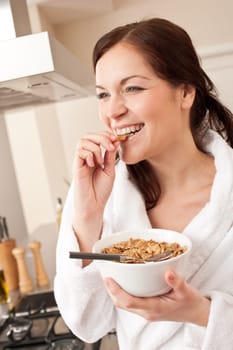 Young woman with cereals in kitchen
