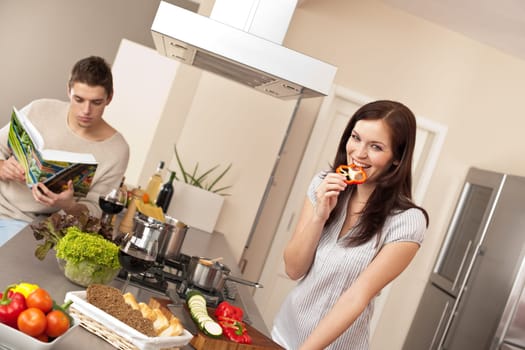 Young couple in kitchen cooking