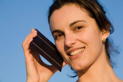 Woman showing a solar cell