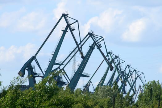 Harbor cranes silhouettes at shipyard