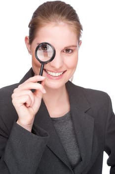 Businesswoman with a magnifying glass in front of her eye
