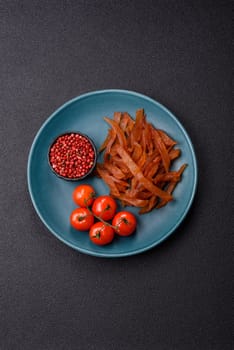 Jerky, dried turkey meat with salt and spices on a dark concrete background