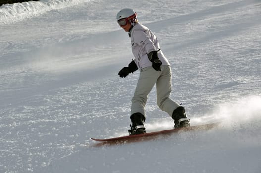 Female snowboarder in powder snow