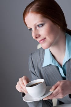 Successful business woman having coffee break