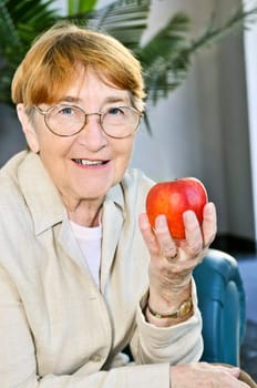 Elderly woman with apple
