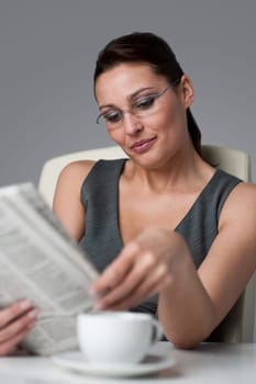 Successful businesswoman read newspaper at office