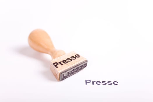Wooden stamp with the word press