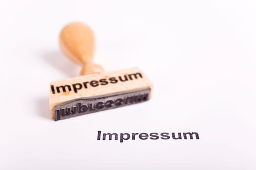 Wooden stamp with the word Imprint