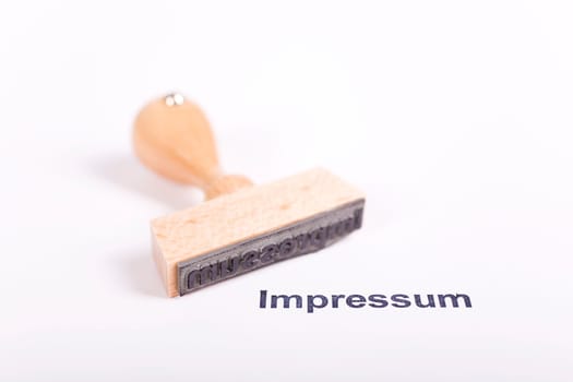 Wooden stamp with the word Imprint