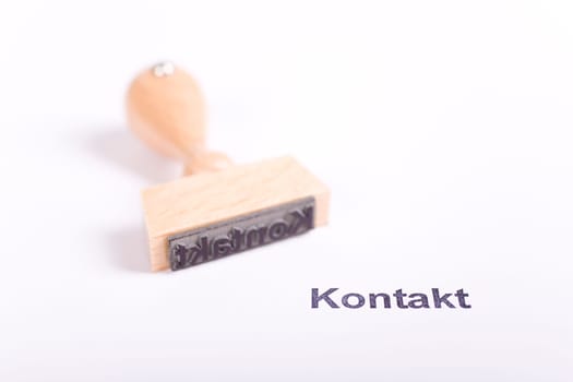 Wooden stamp with the word Contact